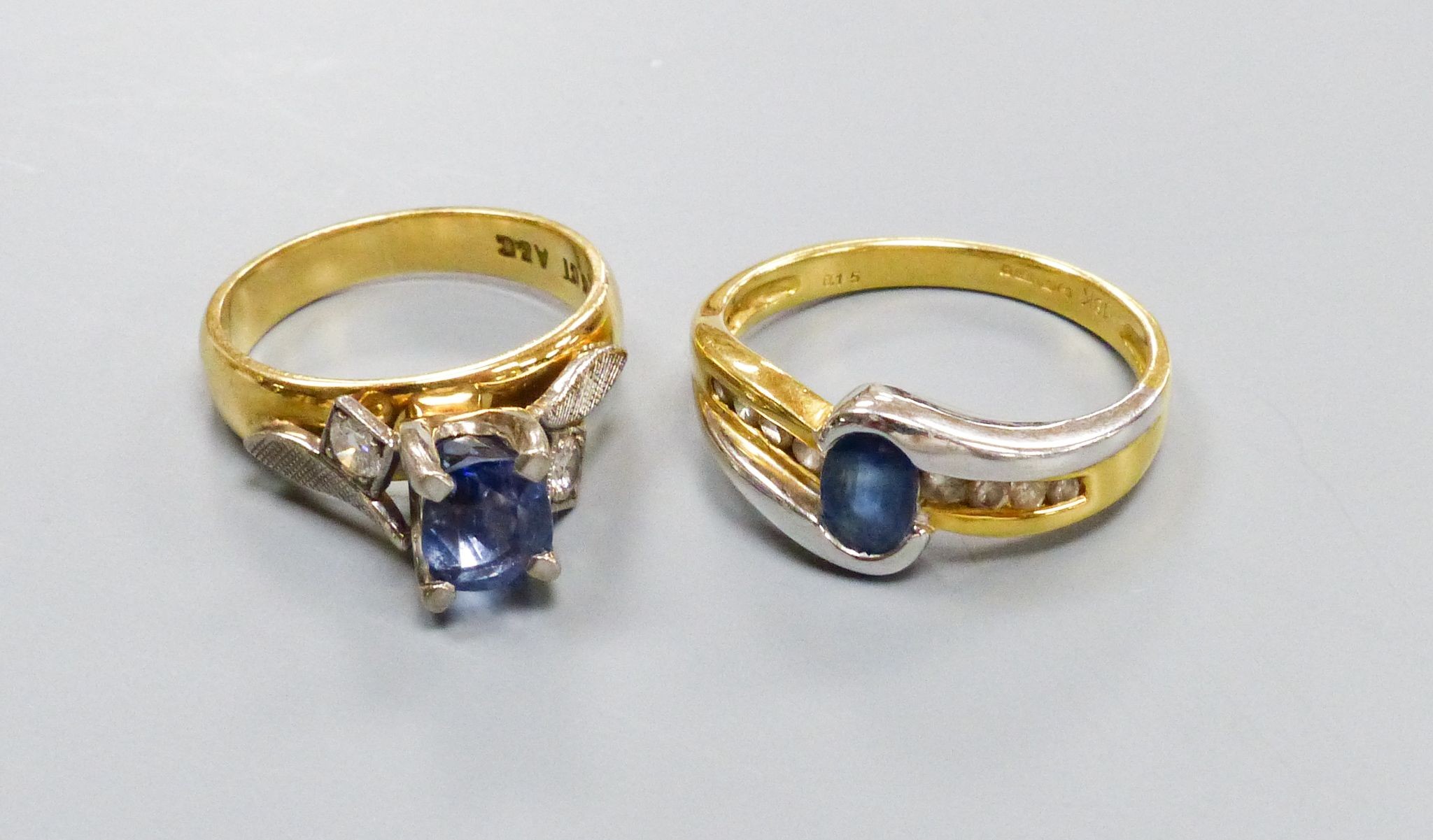 Two modern 18ct gold, sapphire and diamond set dress rings including three stone sizes I & P, gross weight 10 grams.